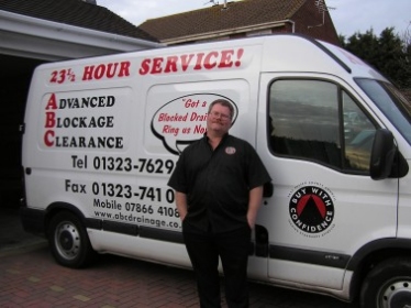 Ross Greenwood standing beside the white ABC van with its 23½ hour service livery